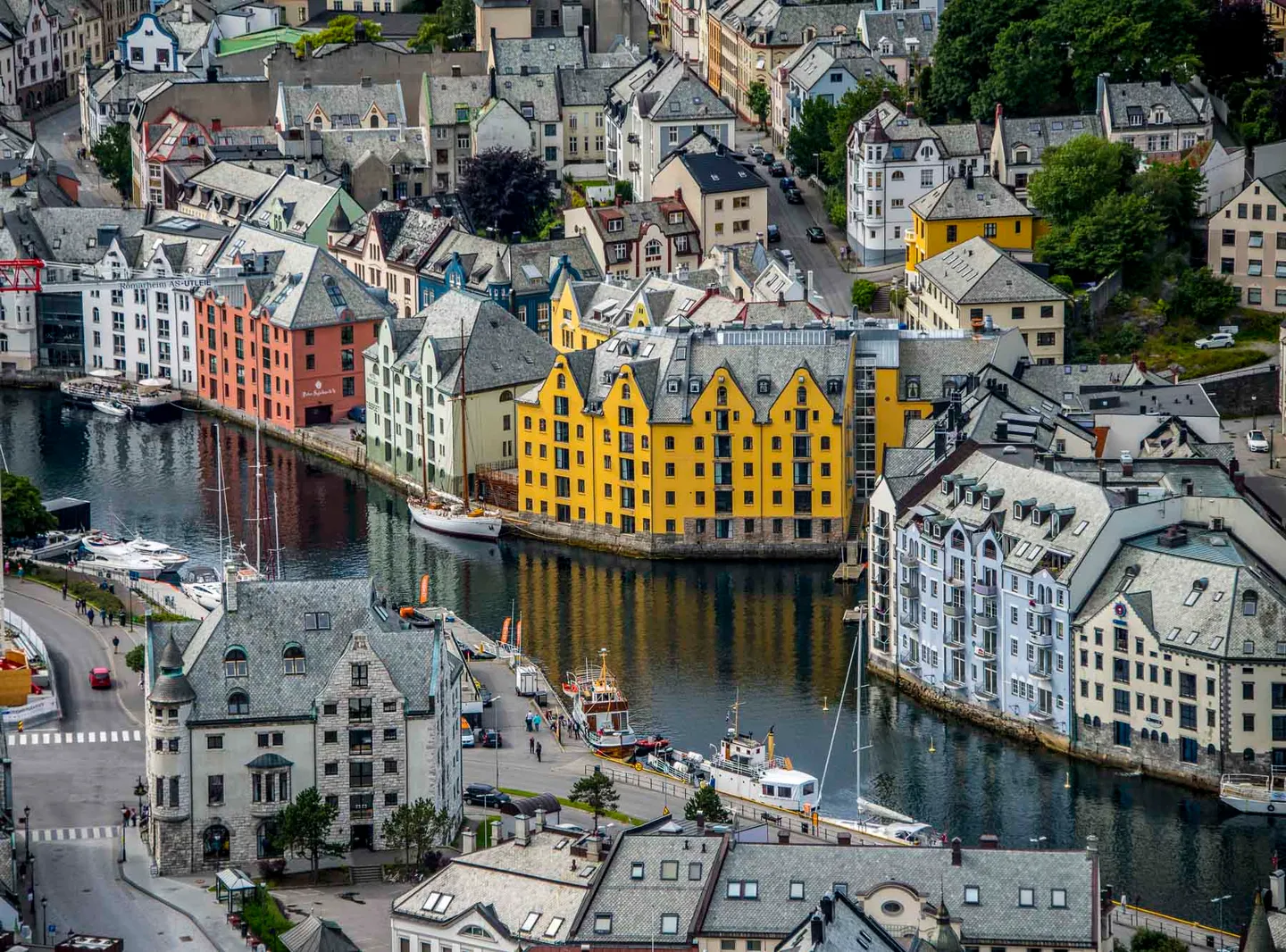 Elevated view across the colorful waterfront and dense rooftops of Ålesund.