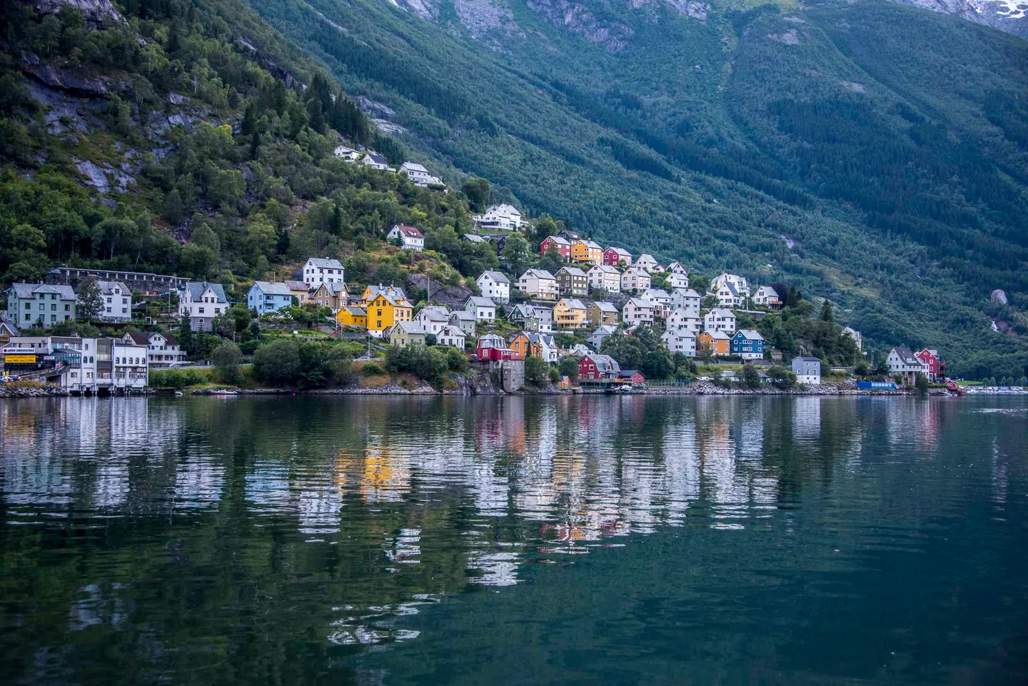 The town of Odda between the fjord and steep Norwegian mountains.